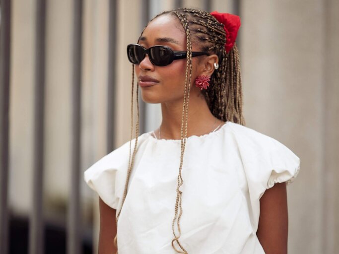 Person mit rotem Scrunchie | © Getty Images/Raimonda Kulikauskiene