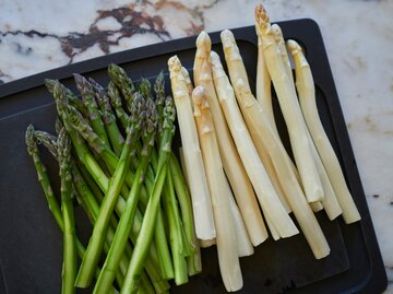 Grüner und weißer Spargel auf einem Blech | © Getty Images/Norman Posselt