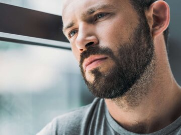 Mann schaut traurig aus dem Fenster | © Adobe Stock/LIGHTFIELD STUDIOS