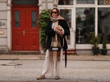 Streetstyle von Elise Seitz in Birkenstock "Boston", Strickhose und -pullover, Mantel und Schal | © Getty Images/Jeremy Moeller